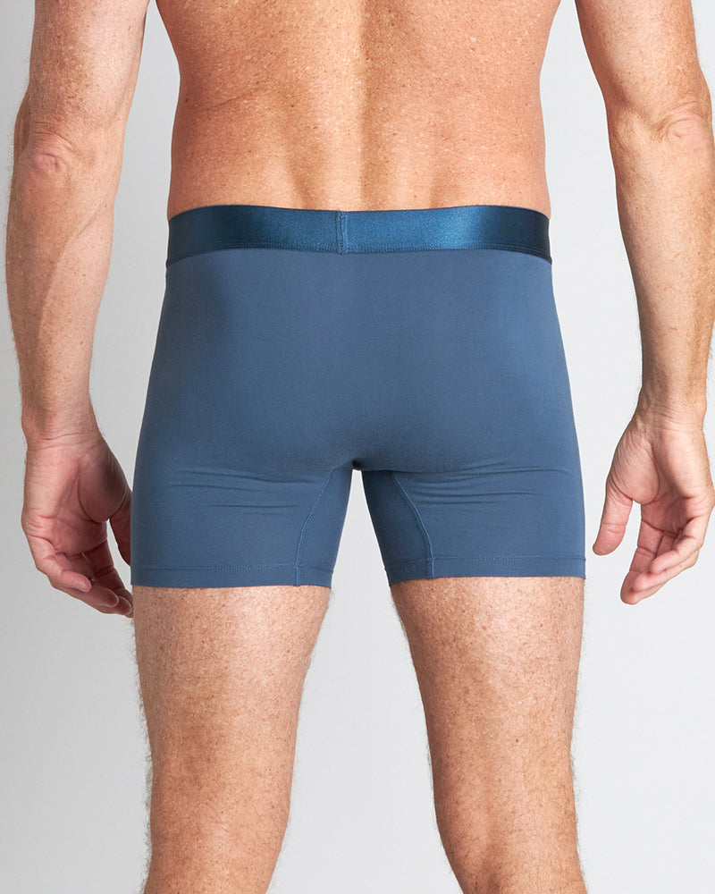 Model wears Bamboo Mens Trunk in BLUE WING TEAL. On body back view