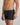 Model wears Cotton Stretch Mens Trunk in BLACK PINSTRIPE. On body side view