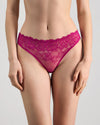 Model wears All Lacey Thong in FANTASY FUCHSIA. On body front view