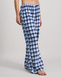 Model wears Cosy Flannel Long PJ Pant in BLUE CHECK. On body side view