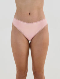 Model wears Stretch Cotton Thong in ICY PINK. On body front view