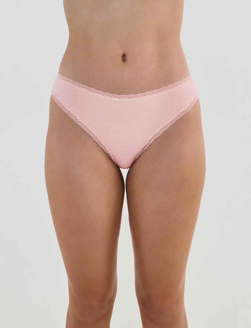 Model wears Stretch Cotton Thong in ICY PINK. On body front view