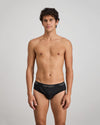 Model wears Cotton Texture Mens Brief in BLACK. On body front view