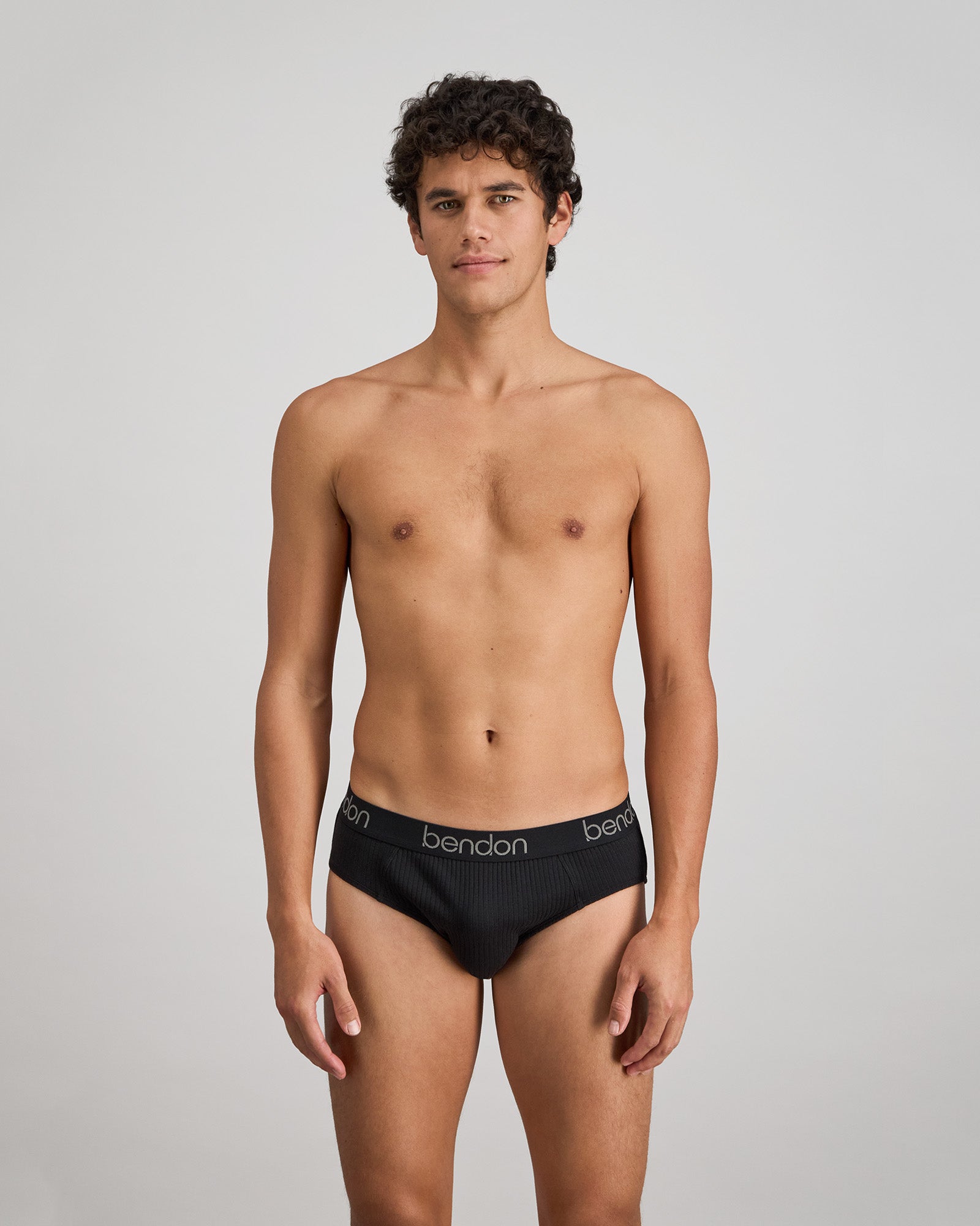Model wears Cotton Texture Mens Brief in BLACK. On body front view