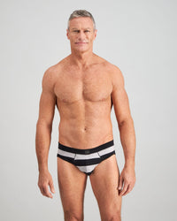 Model wears Rugby Stripe Mens Brief in BLACK RUGBY STRIPE. On body front view