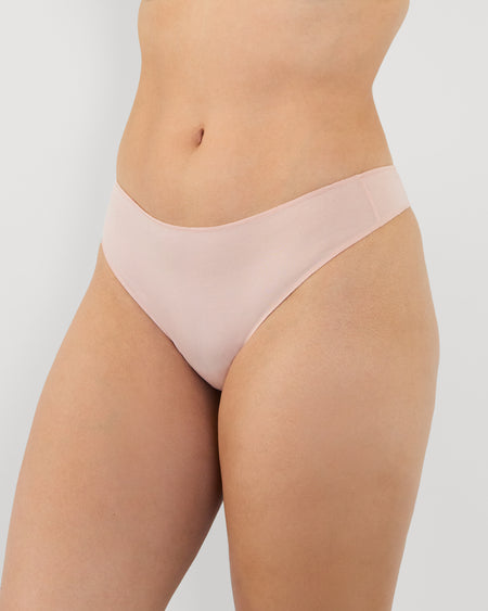 Model wears Au Naturel Thong in LATTE. On body side view