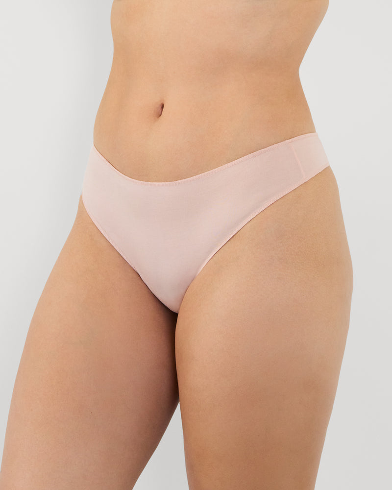 Model wears Au Naturel Thong in LATTE. On body side view