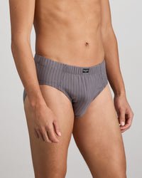 Model wears Cotton Stretch Mens Brief in ASH PINSTRIPE. On body side view