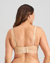 Model wears Bendon Bare Lace Back Strapless Bra in LATTE. On body back view