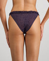 Model wears Wrapped In Stardust Tanga in PURPLE VELVET. On body back view