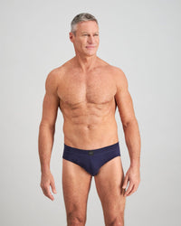 Model wears High Tech Cotton Mens Brief in PEACOAT. On body front view