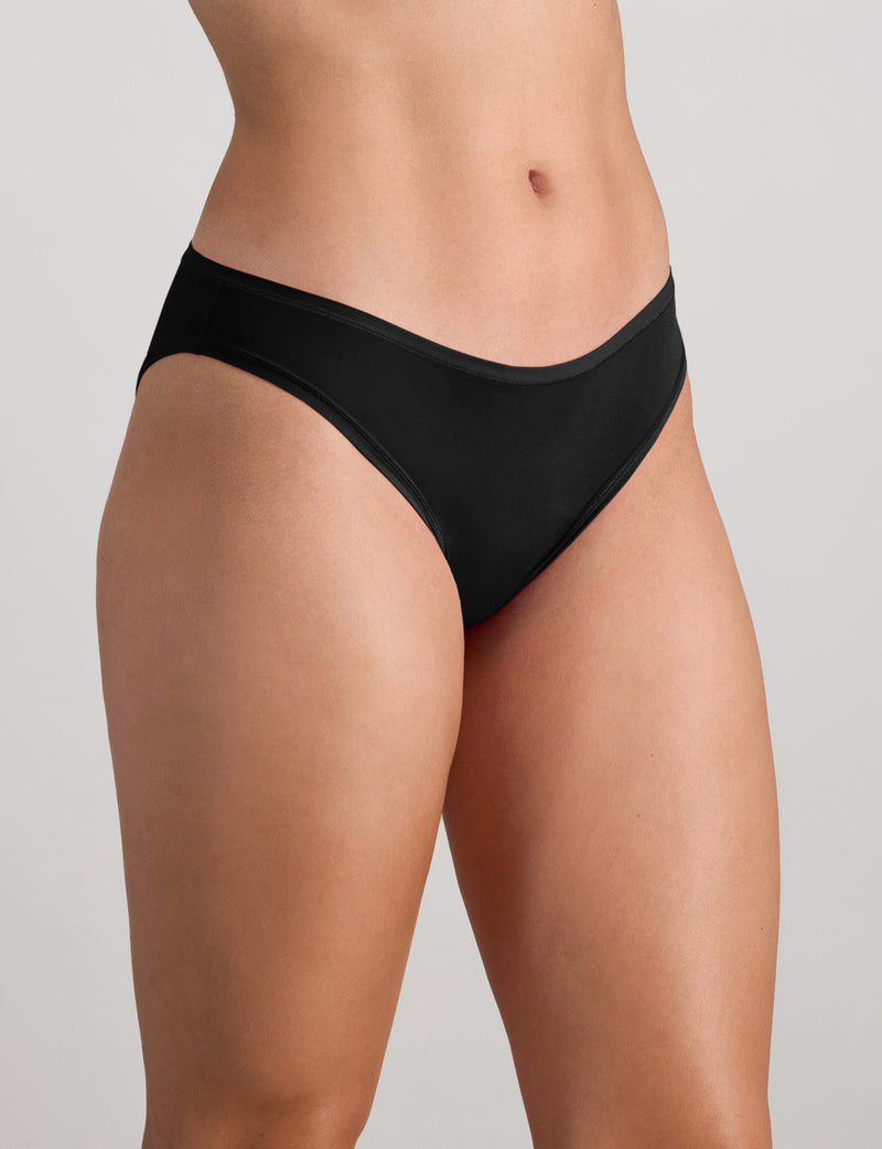 Model wears Extra-Ordinary Bikini Brief in BLACK. On body side view