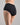 Model wears Freestyle Full Brief in BLACK. On body back view