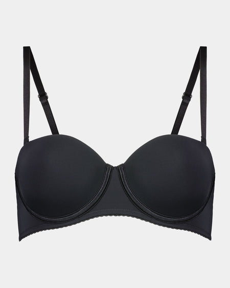 Model wears Body Basics Strapless Bra in BLACK. On body front view