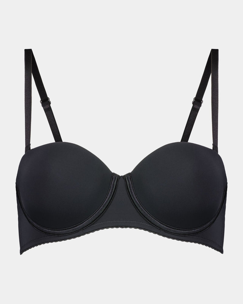 Model wears Body Basics Strapless Bra in BLACK. On body front view