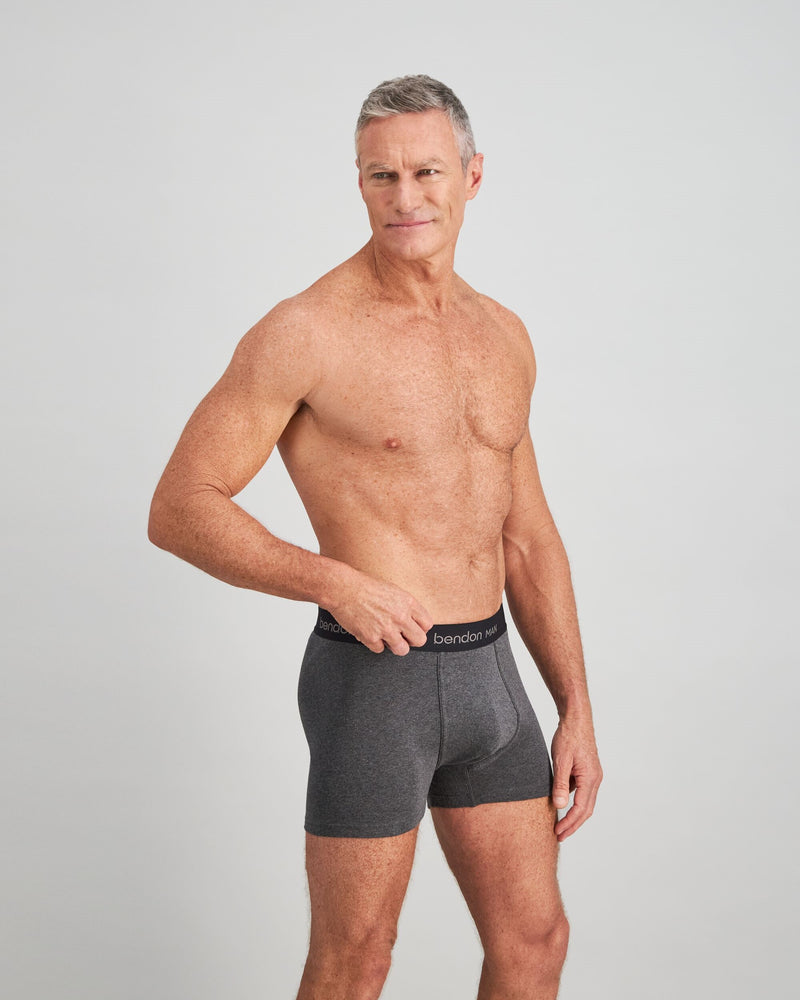 Model wears Cotton Classics Mens Trunk in GREY MARL. On body side view