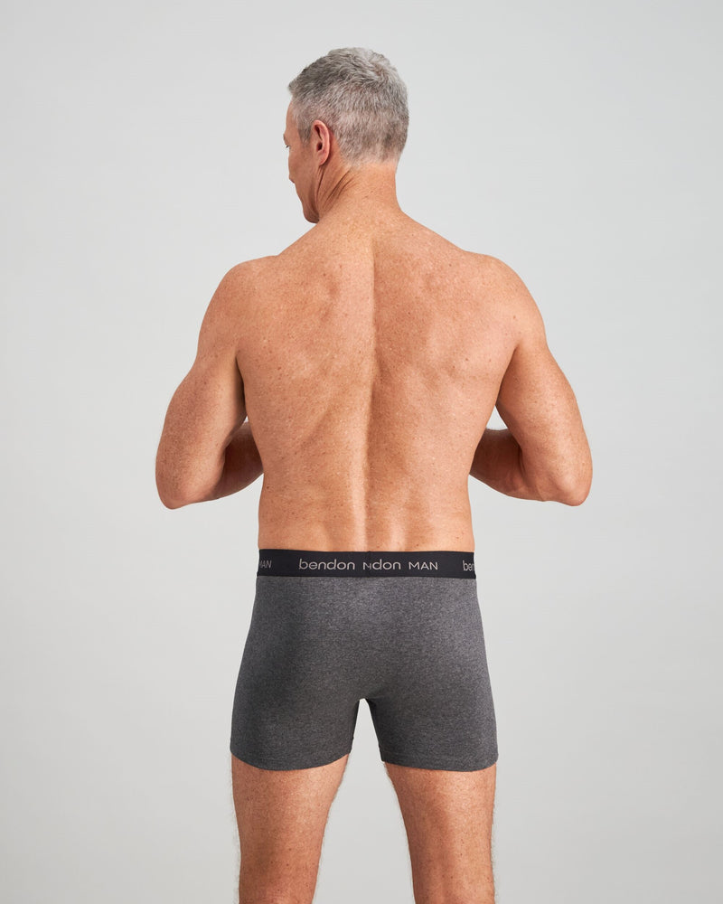 Model wears Cotton Classics Mens Trunk in GREY MARL. On body back view