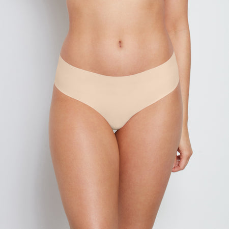 Model wears No Show Bikini in LATTE. On body front view