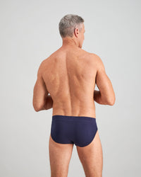 Model wears High Tech Cotton Mens Brief in PEACOAT. On body back view