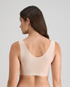Model wears Comfit Collection Crop Top in LATTE. On body back view