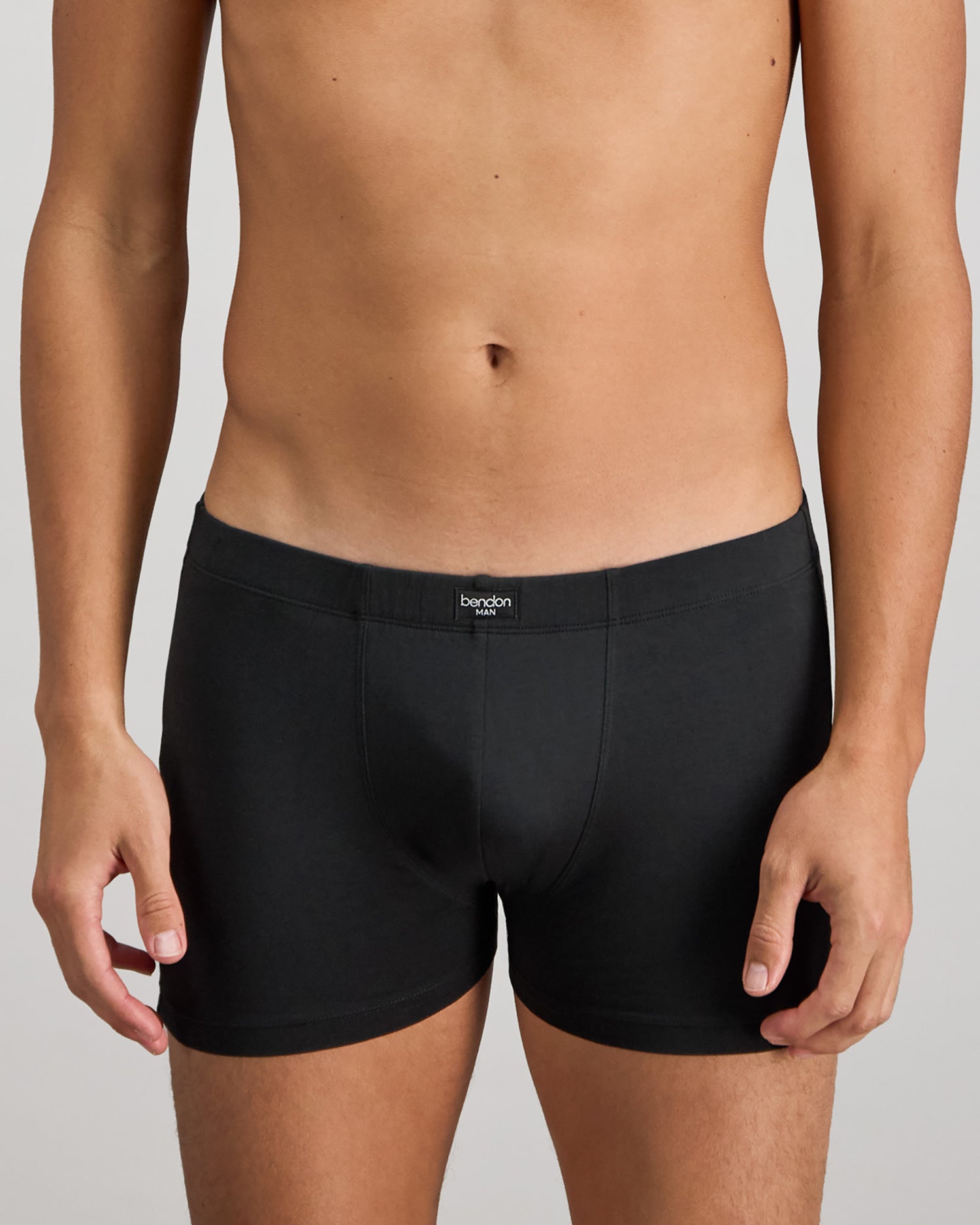 Model wears Cotton Stretch Mens Trunk in BLACK. On body front view