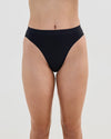 Model wears Seamless Soft High Cut Brief in BLACK. On body front view