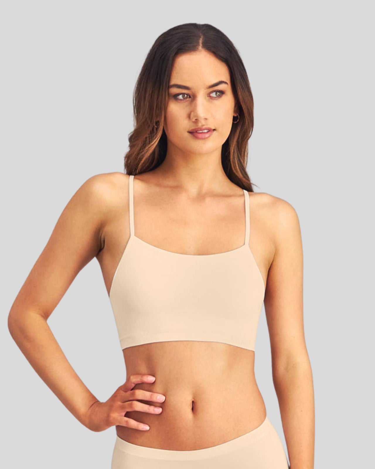 Model wears Simply Seamless Crop Top in Nude. On body side view