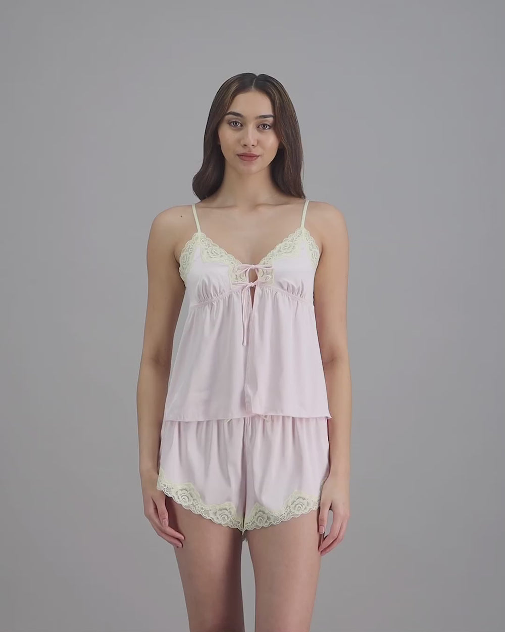 model-poses-in-pink-camisole-and-shorts