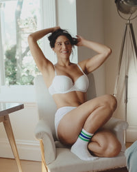 model poses on chair wearing body cocoon lingerie set