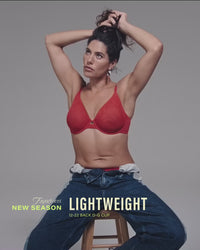 model-ties-hair-up-wearing-red-mesh-bra