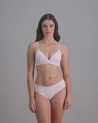 model-poses-in-light-pink-lingerie